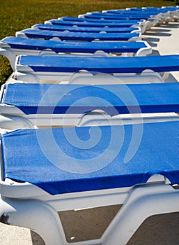 Row of Blue Vinyl Chaise Lounges