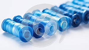 A row of blue and white thread spools