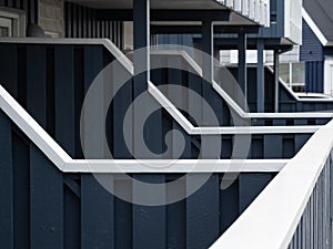 Row of blue wooden fences separating condo units