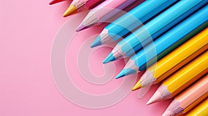 A row of blue, yellow and pink pencils on pink background with copyspace.