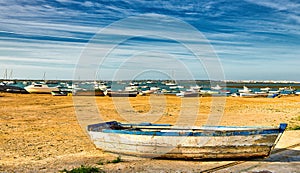 Row boat ashore on the Spanish beach in Sancti Petri