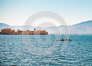 Row boat on lake with mountains behind