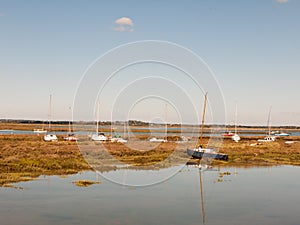 Row boats parked in stream river estuary in tollesbury maldon es