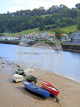 Row boats on river bank at low tide