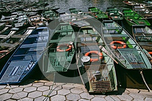 Row Boats of Tam Coc in Ninh Binh Vietnam lined up on shore