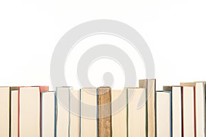 Row of books on a white background with space for copy