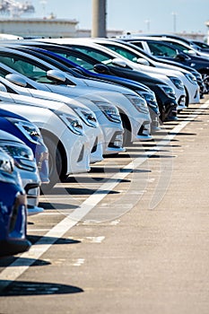 Brand new cars lined up in a parking lot