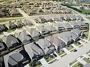 Row of brand new large two story houses with school district in background in North Texas, US