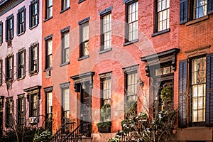 Row of  brick and brownstone New York City apartments seen from outside.