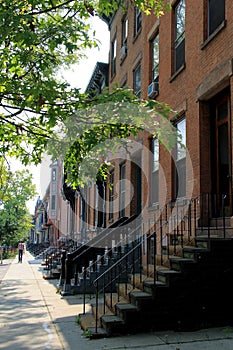 Row of brick homes with solitary man walking away