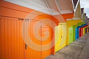 Row of bright colored beach huts.