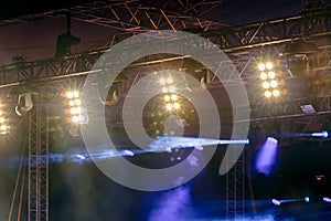 Row of bright spotlights on concert stage