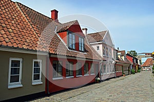 A row of Brightly coloured houses on a cobbled street Denmark