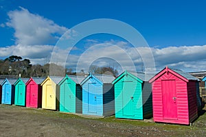 Row of brightly painted beach huts at the small village of Abersoch, Wales