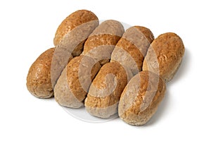 Row of of brown whole grain buns of bread close up on white background