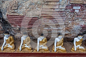 Row of Buddha statues in Kaw Goon cave with.