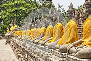 Row of Buddha Statuses at the temple of Wat Yai Chai Mongkol in Ayutthaya near Bangkok, Thailand