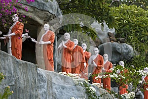 A row of Buddhist monk statues adjacent to the Golden Temple at Dambulla in Sri Lanka.