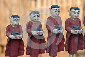 Row of buddhist monks with alms bowls