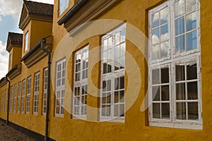 Row of casement windows on yellow house photo
