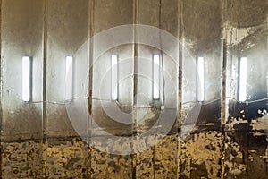 row of CFL fluorescent lamps on burned ceiling of abandoned building