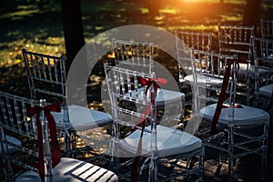 Row of chairs for outdoor wedding ceremony, close-up. Chairs are prepared for the reception