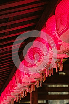 A row of Chinese red lanterns hang on the ceiling