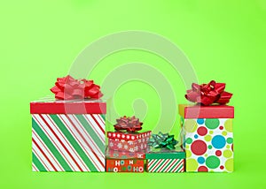 Row of Christmas presents on vibrant green background