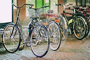 Row Of City Parked Bicycles Bikes In European City In Night Time