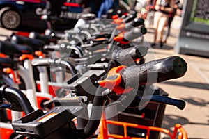 Row of city parked bicycles bikes for rent on sidewalk in