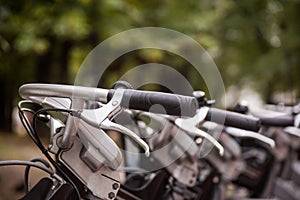 Row of city parked bikes for rent on sidewalk