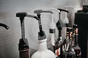 Row of coffee flavoring syrup bottles with dispenser