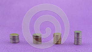 Row of coins thai baht isolated on purple paper background