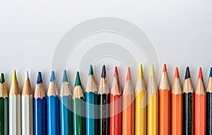 Row of Colored Pencils Against White Background