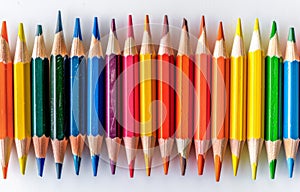 Row of Colored Pencils Against White Background