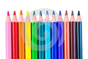 a row of colored pencils sharpened sharply on a white background