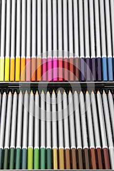 A row of colored pencils in their case