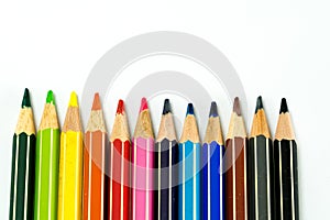 Row of colored pencils on a white background