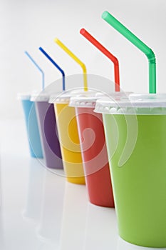 Row Of Colored Soft Drink Beakers With Straws