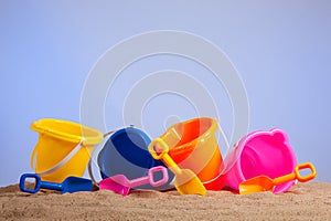 Row of colorful beach buckets or pails