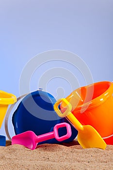 Row of colorful beach buckets or pails