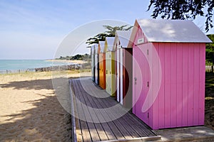 Row of colorful beach huts in the sand beach in atlantic west french coast