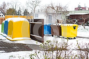 A row of colorful dustbins for waste segregation