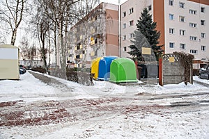 A row of colorful dustbins for waste segregation