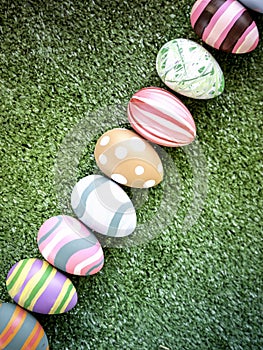 Row of colorful Easter eggs on green grass  festival and holiday spring caming  Easter calibration