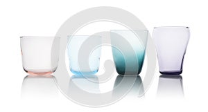 Row of colorful empty glasses on white