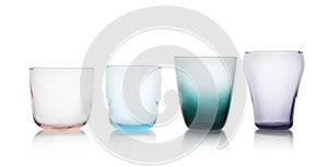 Row of colorful empty glasses on white