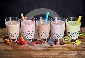 Row of colorful fruit and candy flavored boba tea photo
