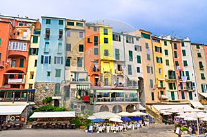 Row of colorful multicolored buildings houses and restaurants of Portovenere coastal town village in harbor of Ligurian sea, Rivie