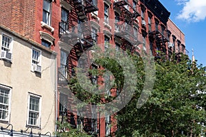 Row of Colorful Old Brick Residential Buildings with Fire Escapes in Greenwich Village in New York City